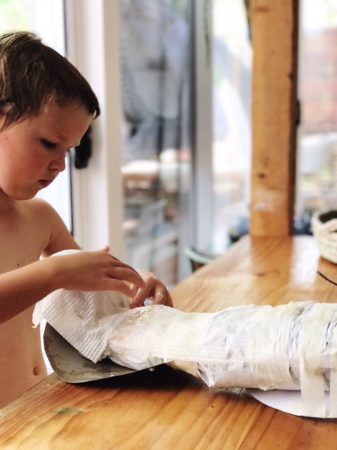 kids making paper mache animal head